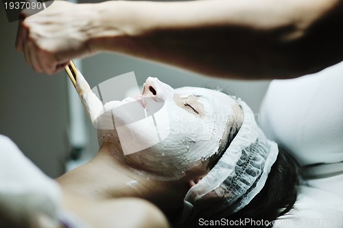 Image of woman with facial mask in cosmetic studio