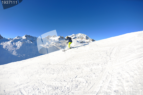 Image of skiing on fresh snow at winter season at beautiful sunny day