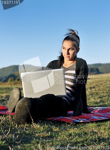 Image of young teen girl work on laptop outdoor