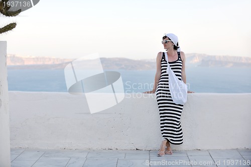 Image of Greek woman on the streets of Oia, Santorini, Greece