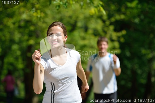 Image of Young couple jogging at morning