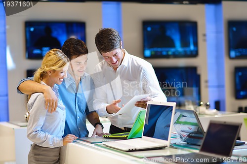 Image of Young couple in consumer electronics store