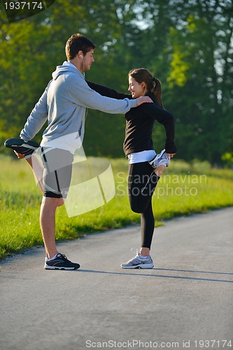 Image of Couple doing stretching exercise  after jogging