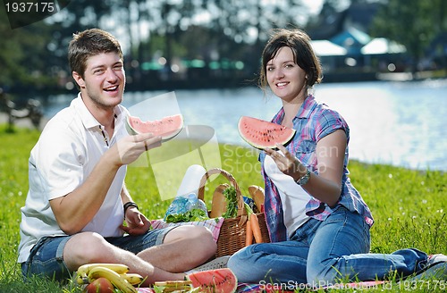 Image of happy young couple having a picnic outdoor