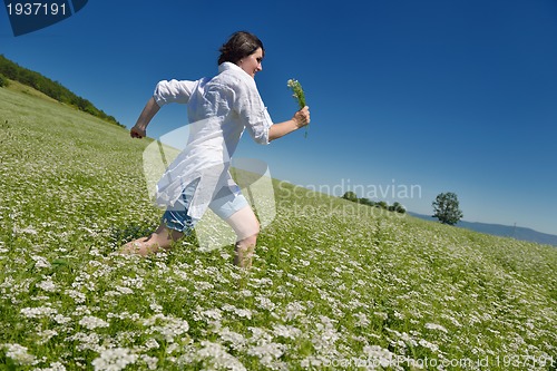 Image of Young happy woman in green field