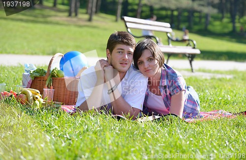 Image of happy young couple having a picnic outdoor