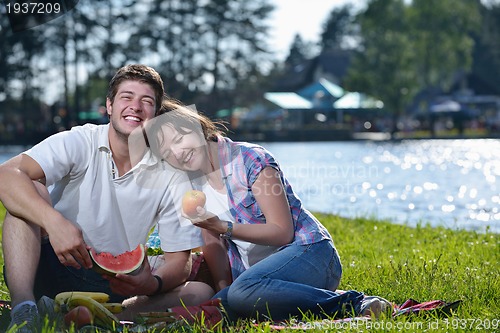 Image of happy young couple having a picnic outdoor