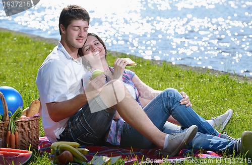 Image of happy young couple having a picnic outdoor