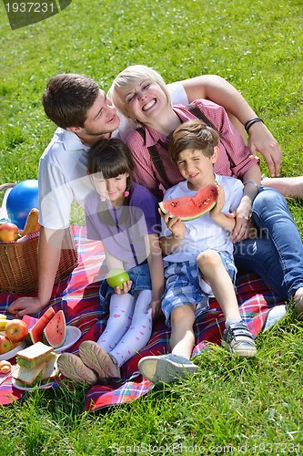 Image of Happy family playing together in a picnic outdoors