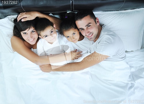 Image of happy young Family in their bedroom