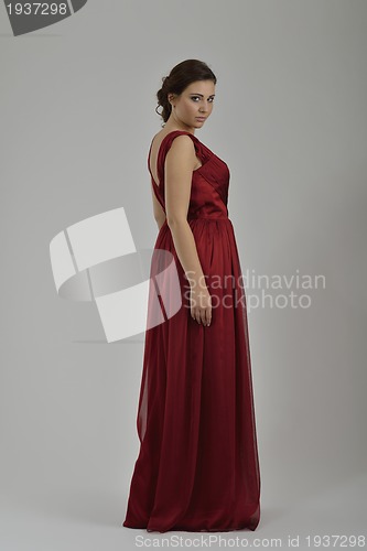 Image of elegant woman in fashionable dress posing in the studio