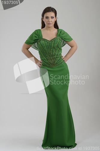 Image of elegant woman in fashionable dress posing in the studio