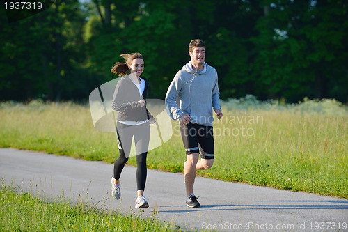 Image of Young couple jogging