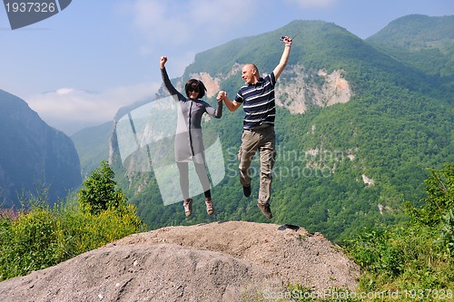 Image of happy young couple jumping in the air