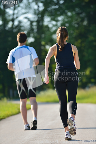 Image of Young couple jogging at morning