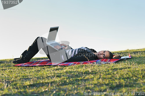Image of young teen girl work on laptop outdoor