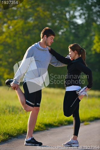 Image of Couple doing stretching exercise  after jogging