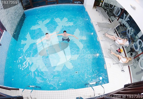 Image of young people group at spa swimming pool