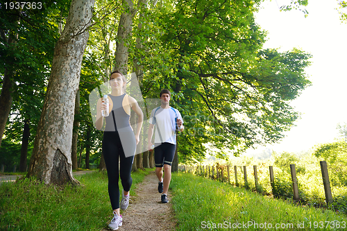 Image of Young couple jogging