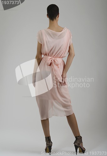 Image of elegant woman in fashionable dress posing in the studio