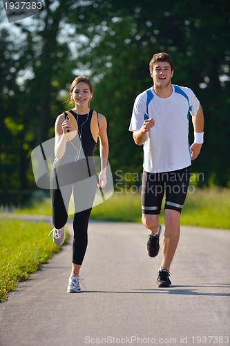 Image of Young couple jogging