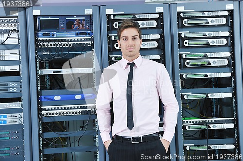 Image of young it engeneer in datacenter server room