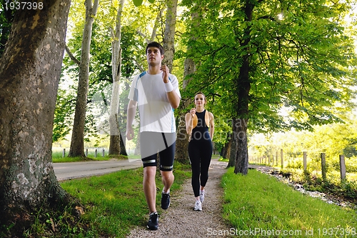 Image of Young couple jogging