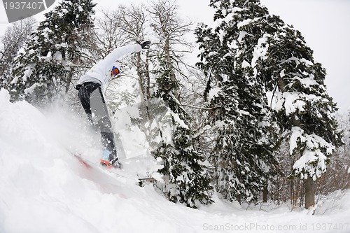 Image of snowboarder on fresh deep snow