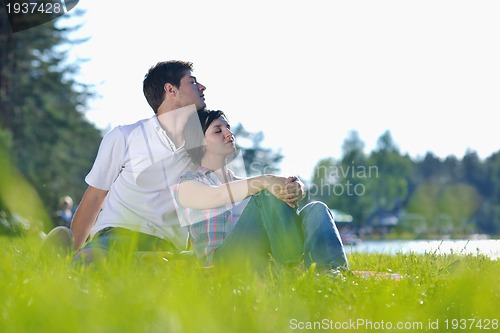 Image of happy young couple having a picnic outdoor