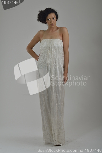 Image of elegant woman in fashionable dress posing in the studio