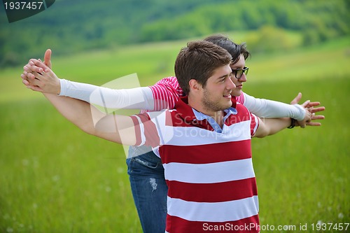 Image of Portrait of romantic young couple smiling together outdoor