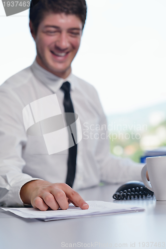Image of happy young business man at office