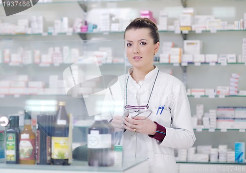 Image of pharmacist chemist woman standing in pharmacy drugstore