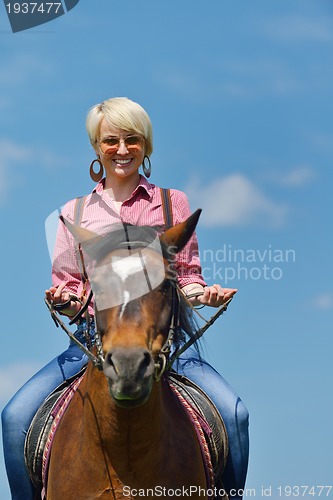 Image of happy woman  on  horse