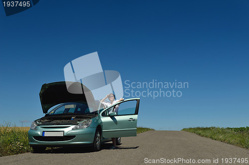 Image of woman with broken car