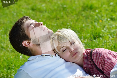 Image of Portrait of romantic young couple smiling together outdoor