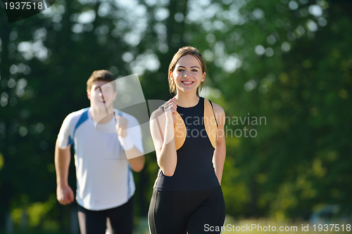 Image of Young couple jogging at morning