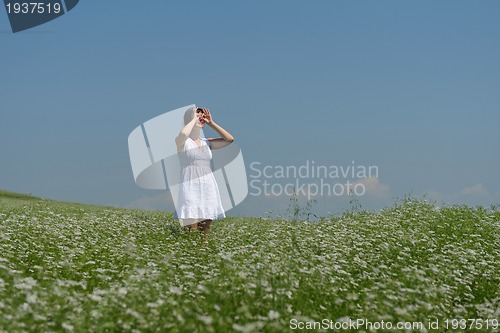 Image of Young happy woman in green field