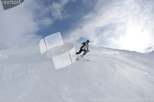 Image of skiing on fresh snow at winter season at beautiful sunny day