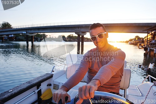 Image of portrait of happy young man on boat