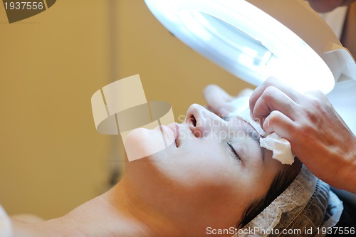 Image of woman with facial mask in cosmetic studio