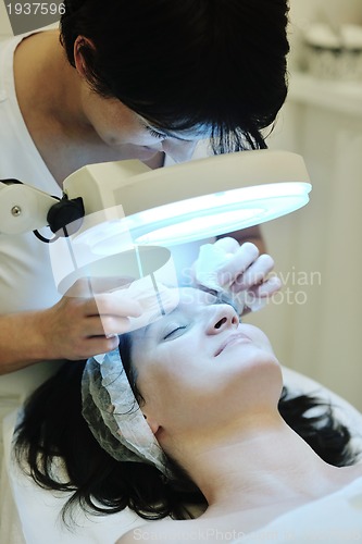 Image of woman with facial mask in cosmetic studio