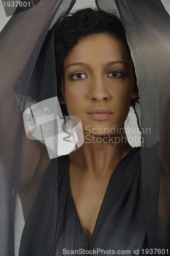 Image of elegant woman in fashionable dress posing in the studio