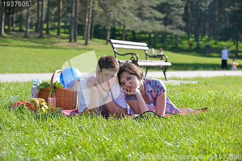 Image of happy young couple having a picnic outdoor
