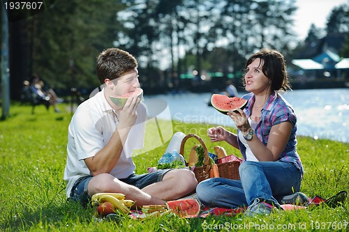Image of happy young couple having a picnic outdoor