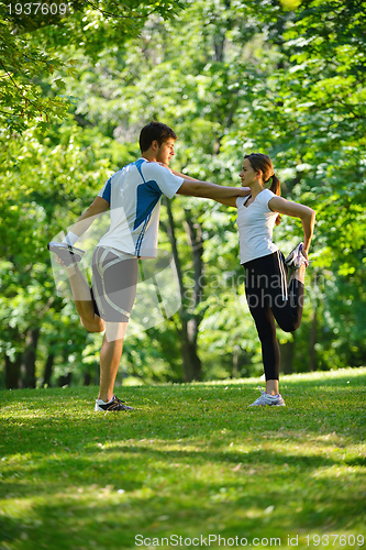 Image of Couple doing stretching exercise  after jogging