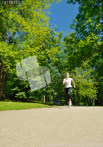 Image of Young beautiful  woman jogging