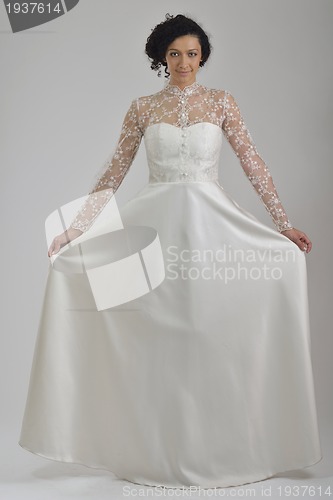 Image of elegant woman in fashionable dress posing in the studio