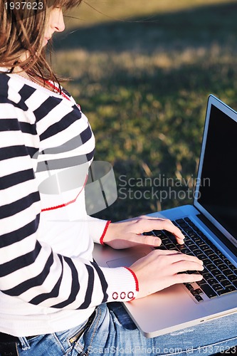 Image of young teen girl work on laptop outdoor