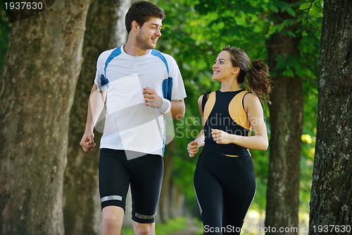 Image of Young couple jogging at morning